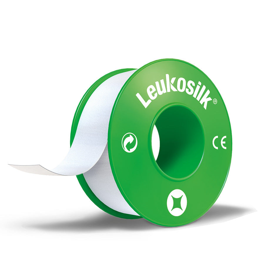 A roll of Leukosilk medical tape, with a green and white color scheme, designed for use on sensitive skin.