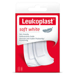Packaging of Leukoplast soft white plasters for sensitive skin, showing the plasters outside the package and the brand name.